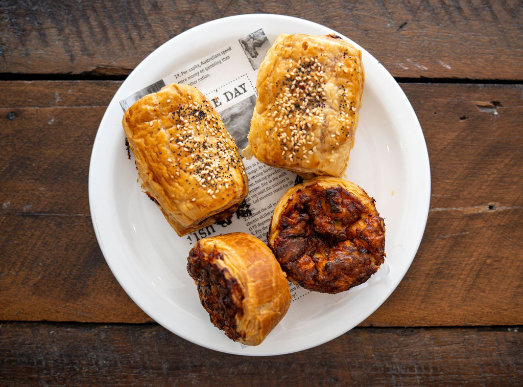 Plate of fresh sausage rolls and savoury pastries