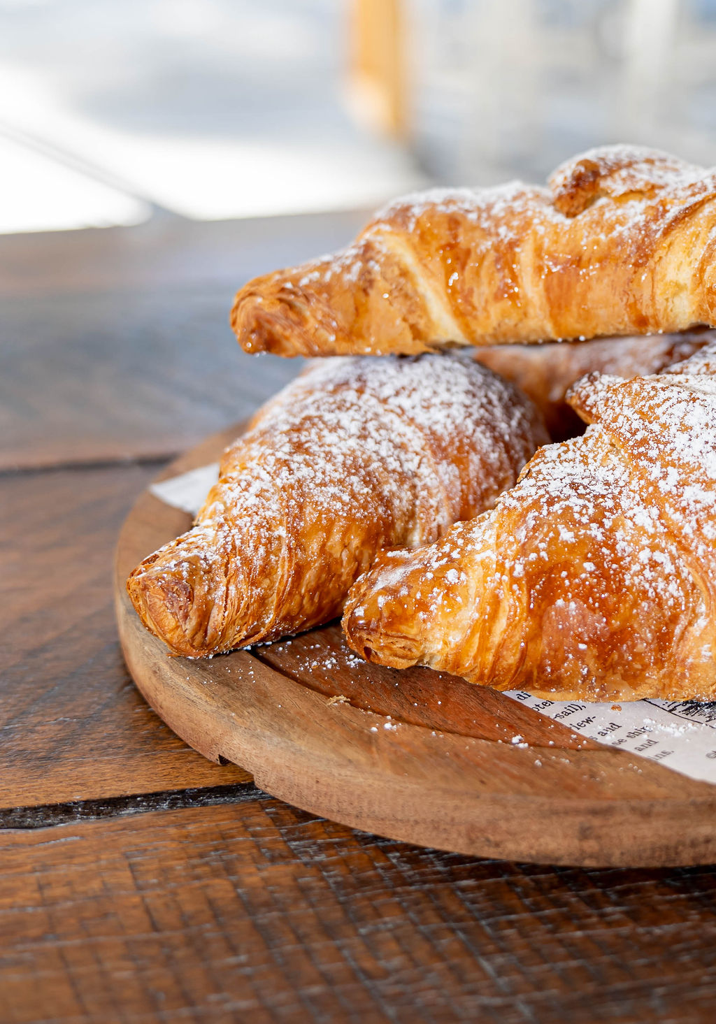 Fresh croissants dusted with icing sugar